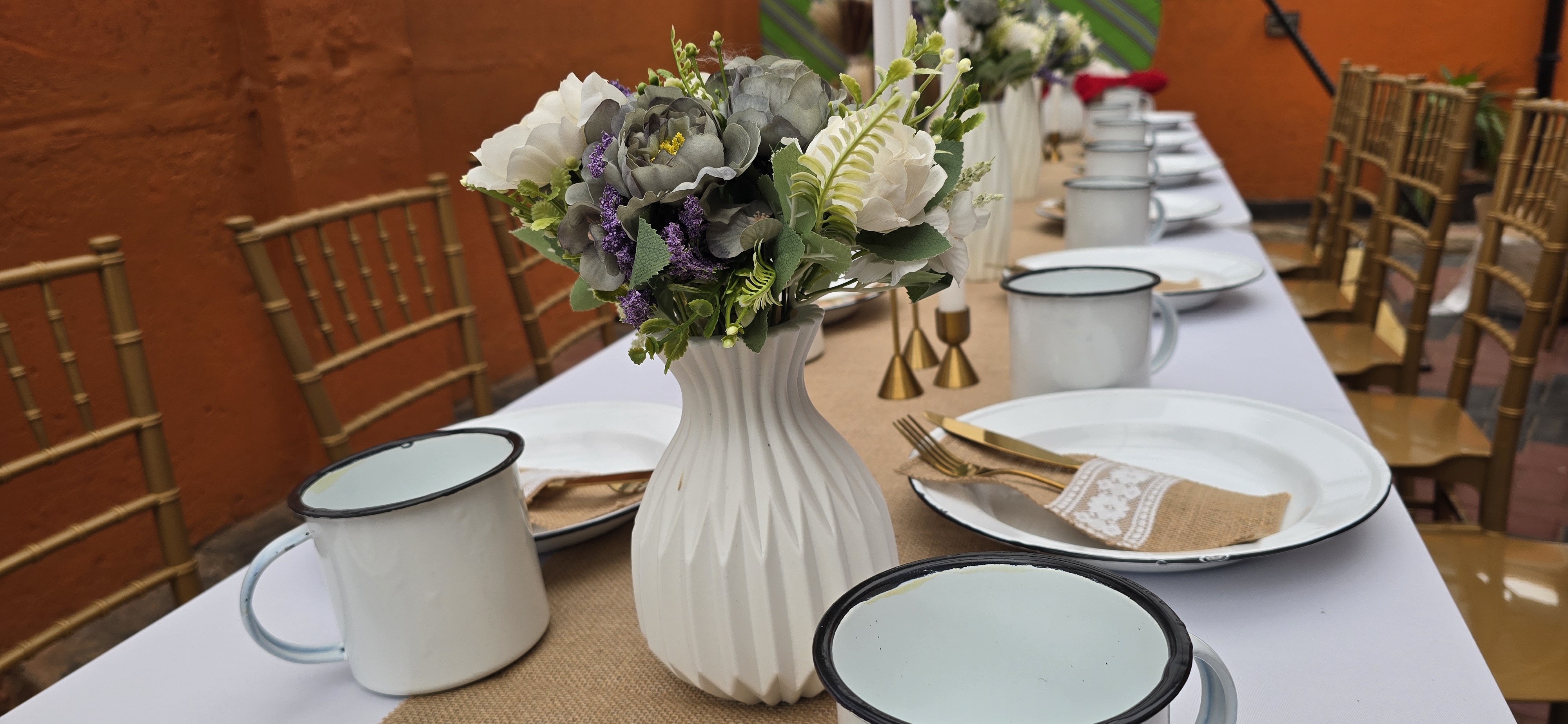 Giggle Factory elegant table setting with gold cutlery, glassware, and decorative plates
